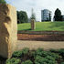 Stone monoliths on the line of a stone wall through the entrance and the reception area