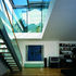 The first floor living room opening to glass lantern above with sliding glazed roof