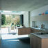 Flow of space into a mature, though equally narrow, garden.  A small, low-maintenance palette of materials has been used