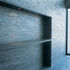 The slate wall extends to the outside