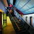 Steel walkways and stairs around the main auditorium provide access to the various levels of the three original buildings