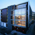 Layered west and south facades; four levels o flats over retail unit