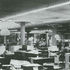 Artful sprawl of the Olivetti newsdesks located at Mezzanine level. Distinctive desk lights identify each workspace