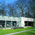 At its northern, more permeable and public,  end the building noses into a copse of mature trees