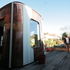 The extension is clad in distinct bronze and translucent panels