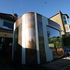 The extension is clad in distinct bronze and translucent panels