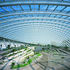 the glass envelope, supported on a tilted ring-beam, creates a good solar collector.  The building is billed as the largest single-span greenhouse in the world