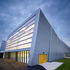 The inclining facade of Ravenscraig, with glazing at low levels and polycarbonate panels above