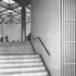 Stairs from the entrance lobby up to the main lobby, with the lift-lobby screen at right