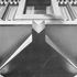 Detail of emposed ends of the first floor structural grid on the main facade, showing effect of light reflected from the pavement