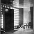 The front door, leading direct on to the covered drive-in, is surrounded by glass-brick walling. The far wall is of matt-surfaced dark red tiles, four inches square