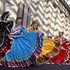 Dancers perform under the patterned shawdows