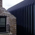 Aluminium ribs contrast with the original stone structure