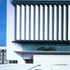 Vertical solar shades are hung from the roof