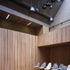 Timber lined walls soften the rooms hard-edged aesthetic