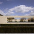 View from arrivals courtyard with entrance courtyard beyond and deep-verged office building on left