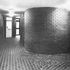 Fairfaced curved brickwork and floor tiles to administrative offices corridor