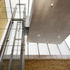 Looking up to suspended concrete slab within glazed enclosure