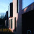 The windows alternate between flush openings and projected bay windows