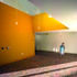 The brick floor surface continues inside to the reception area, complemented by vibrant colour