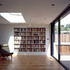 View of the extended living room, with pine parquet floor and triple sliding doors opening to the garden
