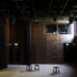 A drama studio with dark-stained fire-treated birch plywood wall panels