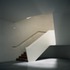 The stairways are cantilevered off a wall of white Belgian brick