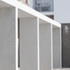 The bays of the concrete frame form a cloister around the perimeter of the external space