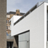 The older, three-storey building steps up to meet the street