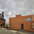 The building drops down to a single storey, which cranks to create storage and a covered cycle shed