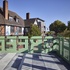 A pale green painted steel balcony provides shelter over the entrance beneath