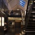 The upper floor was opened volumetrically by removal of steel cross-bracing to the pitched roof