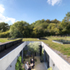 The living space is divided by a large inset court punched into the broad roof