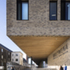 A large cantilever overhang shelters the entrance
