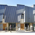 A  zinc-clad sculptural form folds out from the concrete below