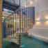 A spiral staircase winds down through the lightwell
