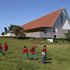 The building overlooks a landscape of lush green valleys 