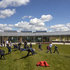 Children play on grassy mounds rather than walled playgrounds