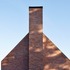 The chimney stacks are articulated separately from the rest of the house