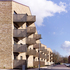 The cantilevered concrete balconies are clad in perforated and corrugated anodised aluminium panels