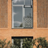 Corduroy brickwork panels give rhythm and texture to the façade