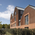 The panels consist of vertically laid bricks in two different colours with dark-red 65mm bricks forming the backdrop to projecting light-red 50mm brickwork bands