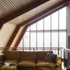 Portal frames in Douglas fir support curved walls, so that the rooms widen as they rise up