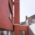 The red brick stack rises up beyond the roofline