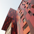 Window openings – limited, tall and narrow – are recessed into the inner line of the façade to reduce solar gain