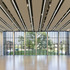 A slender precast concrete colonnade gives the building a deep, animated edge