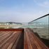 The experience of being surrounded by sea and ‘walking on water’ is heightened visually by the louvred balustrade design and the quality of the timber deck