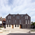 The front façade includes a number of blank panels enlivened by bespoke ceramic tiles