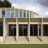 The auditorium is expressed in the external composition by a curved clerestory element of vertical stone fins alternating with glazing
