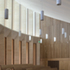 The fins incorporate pockets for the doors so that they can disappear, and appear at the push of a button to separate the spaces when the auditorium is in lecture mode